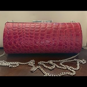 La Regale red/wine faux reptile patent leather clutch with silver hardware.